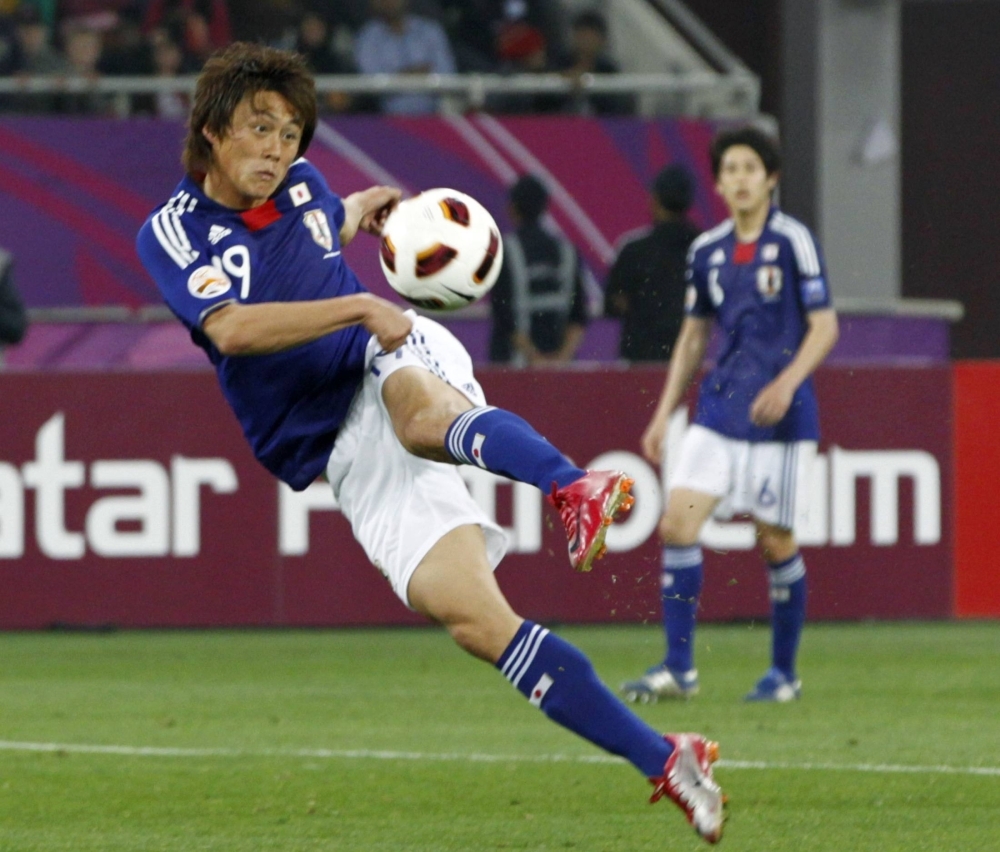 Japan's Tadanari Lee scores against Australia in extra time during the Asian Cup final in Doha in January 2011.