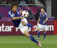 Japan's Tadanari Lee scores against Australia in extra time during the Asian Cup final in Doha in January 2011. | REUTERS