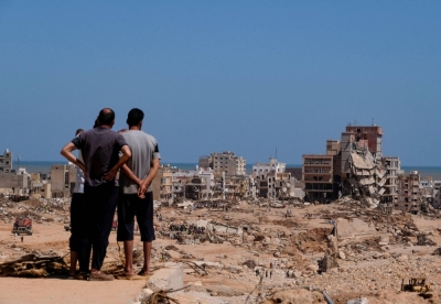 People look on at what remains of Derna, Libya, on Thursday.