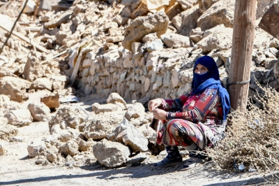 A woman sits near debris in the earthquake-hit village of Ardouz, in Morocco's Amizmiz region, on Thursday.