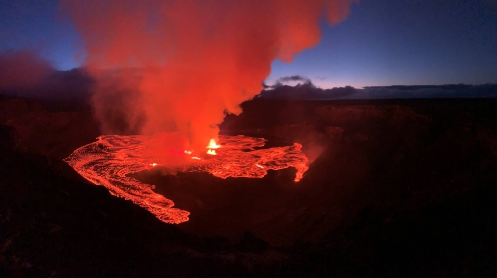 Lava flows on the Halema'uma'u crater floor alongside several active vent sources as the Kilauea volcano erupts in Hawaii on June 7