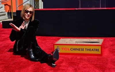 Japanese singer Yoshiki strikes his "X" pose during a ceremony at the TCL Chinese Theatre in Hollywood, California, on Thursday.