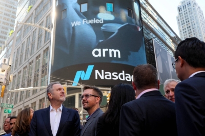 Arm executives gather outside the Nasdaq Market site, as the chip design firm held an initial public offering in New York on Thursday.