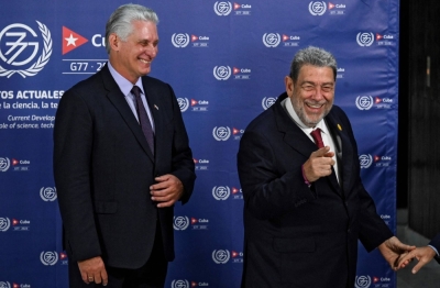 Cuban President Miguel Diaz-Canel (left) laughs as he welcomes Saint Vincent and the Grenadines' Prime Minister Ralph Gonsalves during the G77+China summit at the Convention Palace in Havana on Friday.