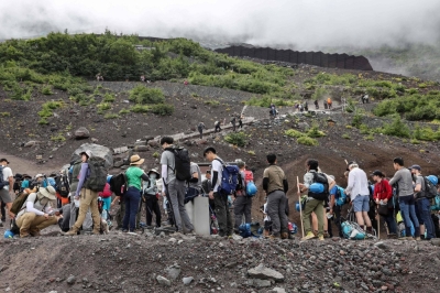 Visitors climb the slopes of Mount Fuji on Aug. 31. The mountain has long been a popular destination for both domestic and international travelers.
