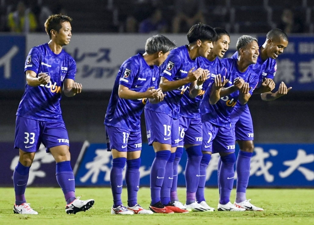 Sanfrecce players celebrate Takaaki Shichi's (third from right) first-half opener against Vissel in Hiroshima on Saturday.