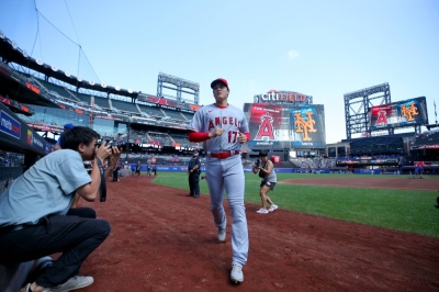 Angels two-way star Shohei Ohtani runs to the dugout after warming up before a game against the New York Mets at Citi Field in New York on Aug. 27.  