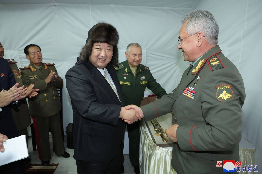 North Korean leader Kim Jong Un shakes hands with Russian Defense Minister Sergei Shoigu after receiving a gift at their luncheon during Kim's visit to the port of Vladivostok, Russia, on Saturday.