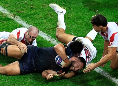 England's Ellis Genge (center) is tackled by Japan's Craig Millar (left) and Tomoki Osada during their match at the Rugby World Cup in Nice, France, on Sunday.
