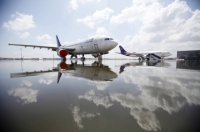 A Thai Airways Airbus A300 sits parked on the flooded tarmac at Don Muang airport in Bangkok. | REUTERS