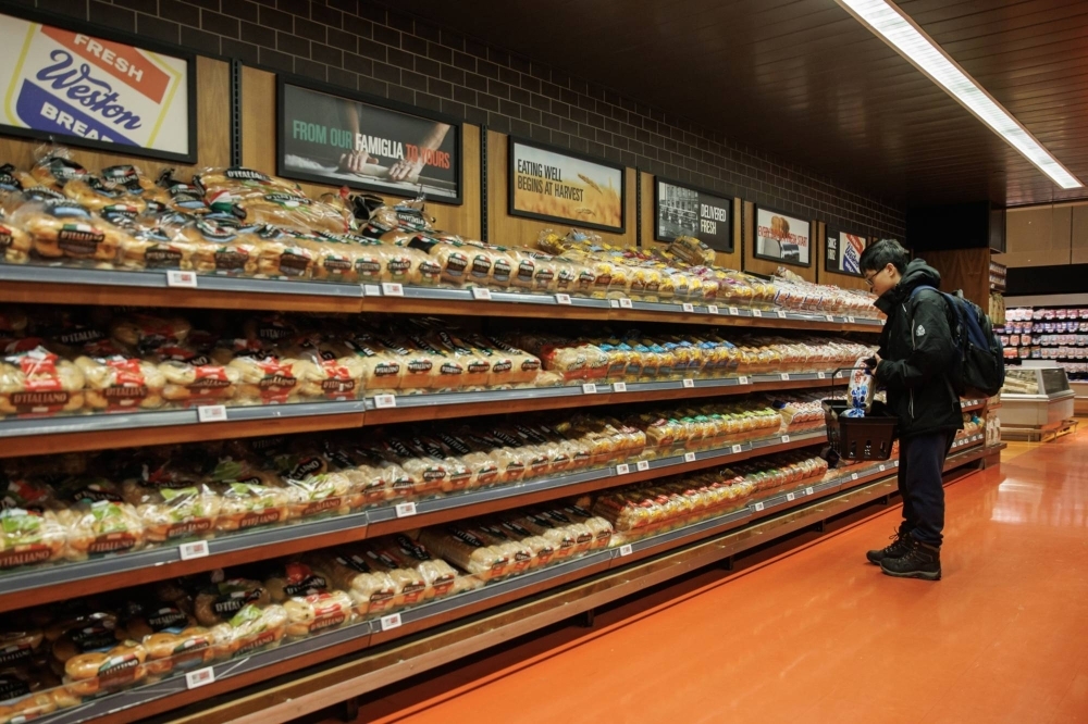 A shopper peruses the bread aisle at a grocery store in Toronto on Sunday.
