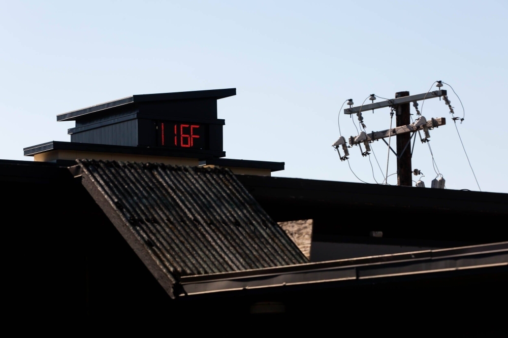 A thermometer indicates extremely high temperatures during a heat wave in Portland, Oregon, in 2021.