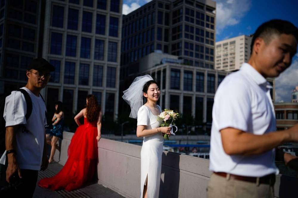 Couples prepare to have their photo taken during a wedding photography shoot on a in Shanghai on Sept. 6.