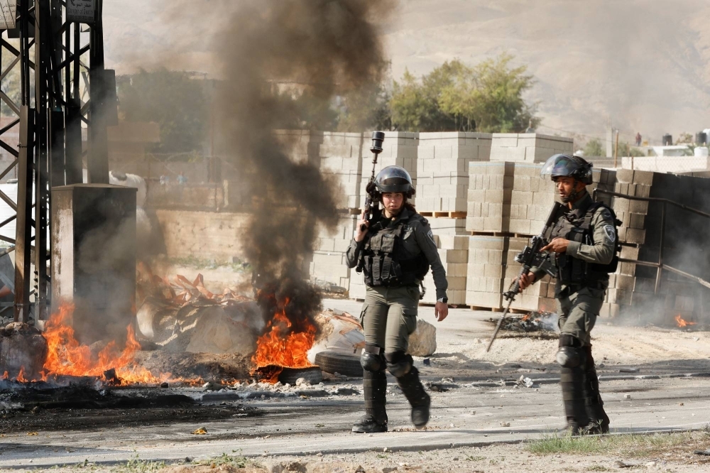 Israeli soldiers clash with Palestinians during a raid into Jericho in the Israeli-occupied West Bank in March.
