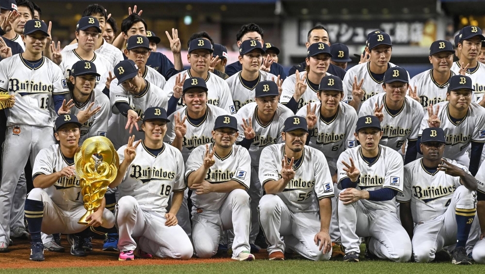Orix Buffaloes players pose for a commemorative photo after securing the PL pennant with their victory against Chiba Lotte Marines at Kyocera Dome Osaka on Wednesday.