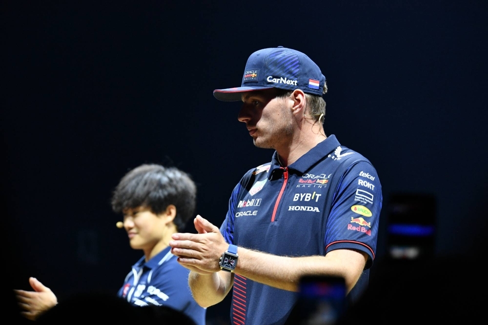 Red Bull's Max Verstappen (right) and AlphaTauri's Yuki Tsunoda take part in a fan event in Tokyo on Wednesday, ahead of the Japanese Grand Prix in Suzuka, Mie Prefecture, at the weekend.