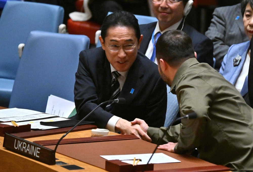 Ukrainian President Volodymyr Zelenskyy shakes hands with Prime Minister Fumio Kishida during a high-level Security Council meeting on the situation in Ukraine on the sidelines of the 78th U.N. General Assembly, at the U.N. headquarters in New York City on Wednesday.