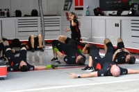 Haas crew members go through stretching exercises on Friday morning. | Dan Orlowitz