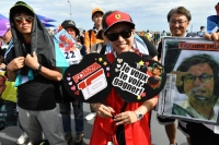 A fan supports Ferrari driver Charles Leclerc in the Suzuka Circuit fan zone on Friday. | Dan Orlowitz