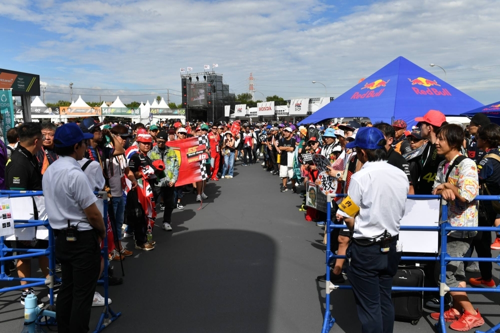 Autograph-seeking fans line the entrance to the fan zone outside Suzuka Circuit on Friday.
