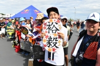 A Yuki Tsunoda fan poses outside Suzuka Circuit. | Dan Orlowitz
