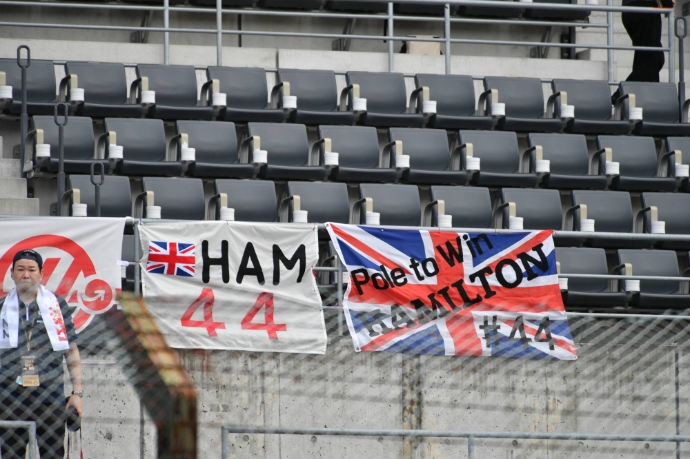 Banners supporting Mercedes driver Lewis Hamilton are hung from the main grandstand on Friday.