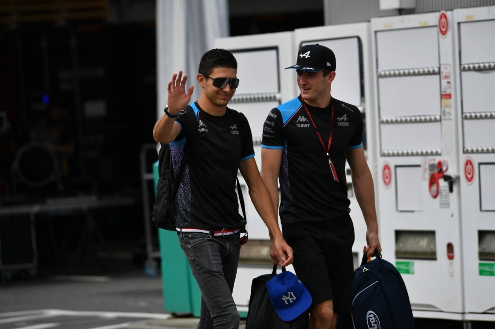 Alpine's Esteban Ocon (left) arrives at Suzuka Circuit on Friday morning.