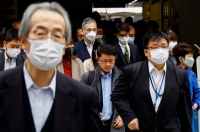 Commuters wear masks in Tokyo. The number of new influenza cases reported at designated medical institutions in Japan has surged 57% over the past week, health ministry data has shown. | REUTERS