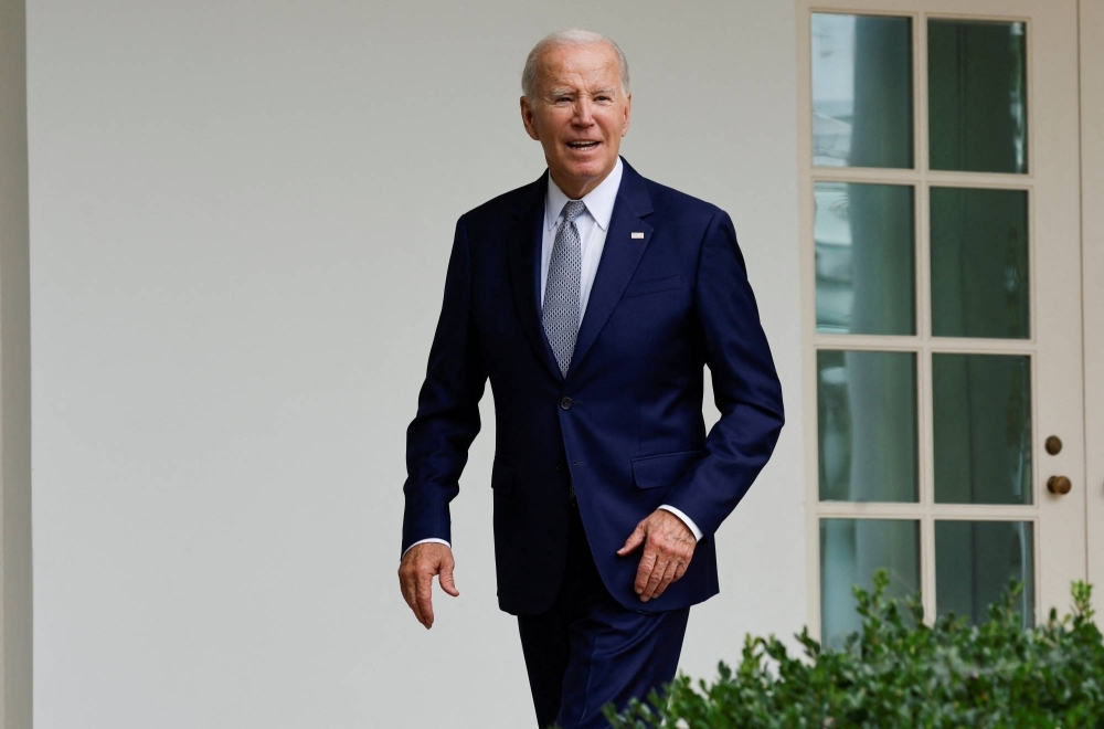U.S. President Joe Biden listens to a reporter's question about whether he will visit striking auto workers on the UAW picket line as he walks back to the Oval Office after an event in the Rose Garden of the White House in Washington on Friday.