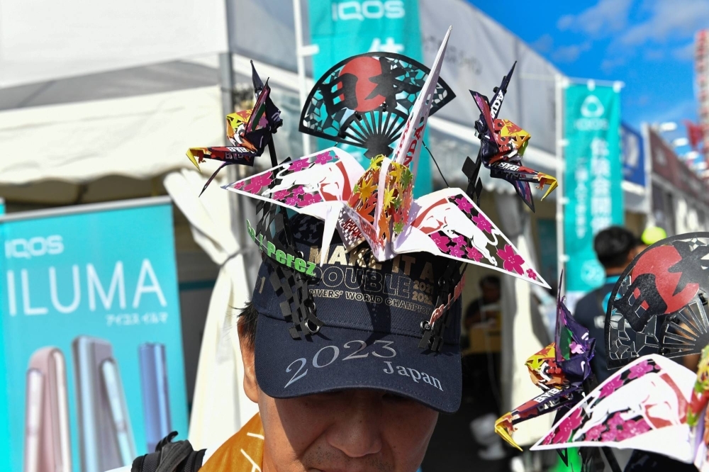 Fans display the origami hats they crafted for the Japanese Grand Prix