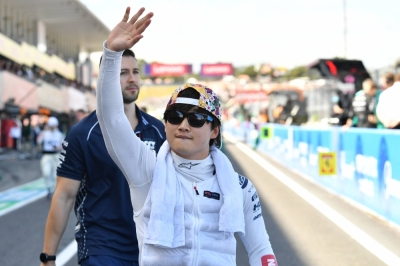 AlphaTauri's Yuki Tsunoda waves to the crowd prior to the start of the Japanese Grand Prix.