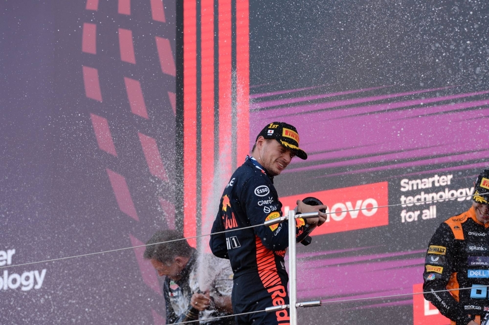 Verstappen participates in the celebratory champagne shower.