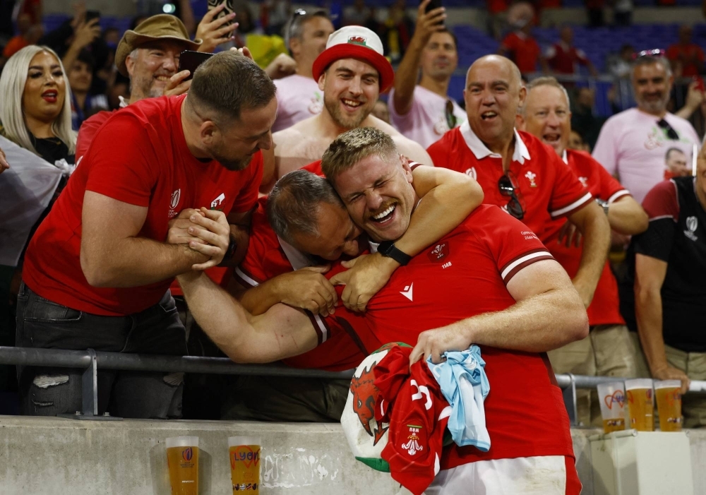 Wales' Aaron Wainwright celebrates with fans after his team's win over Australia at the Rugby World Cup in Lyon, France, on Sunday.