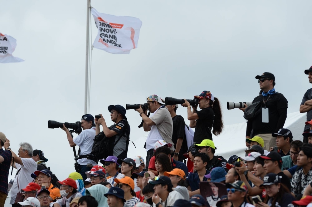Fans shoot Friday's second practice session at Suzuka Circuit.