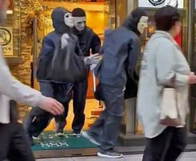 A screen grab from video footage taken by an eyewitness shows three masked suspects fleeing a Rolex specialty store in Tokyo's Ginza district in May.