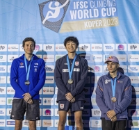 Winner Sorato Anraku (center), second-place Shion Omata (left) and third-place Taisei Homma stand on the podium of the men's final at a sport climbing lead World Cup event in Wujiang, China, on Sunday. | Jan Virt / IFSC / via Kyodo