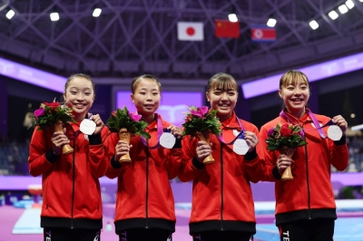 (From left) Misaki Masui, Mana Okamura, Kohane Ushioku and Mikako Serita celebrate after winning silver in the artistic gymnastics women's team event at the 2022 Asian Games in Hangzhou, China, on Monday.