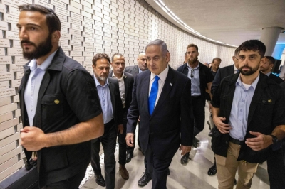 Israeli Prime Minister Benjamin Netanyahu (center) leaves after the state commemoration ceremony for fallen soldiers on the 50th anniversary of the 1973 Arab-Israeli war, at the Memorial Hall on Mount Herzl in Jerusalem on Tuesday.