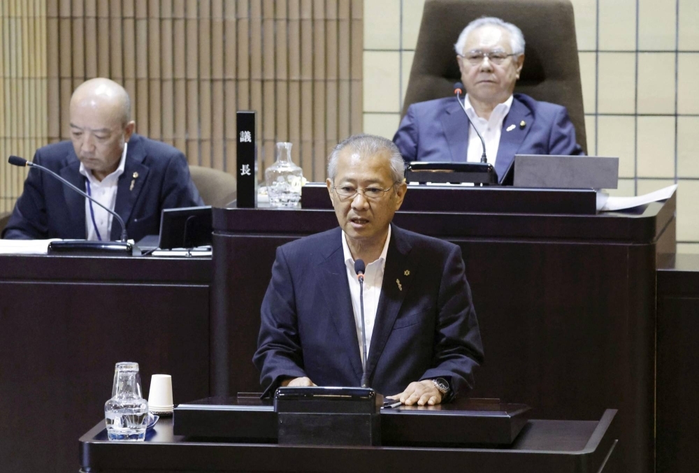Tsushima Mayor Naoki Hitakatsu addresses the city's municipal assembly on Wednesday, announcing his decision not to take part in the government's preliminary survey to assess the suitability of a location as a nuclear waste disposal site.