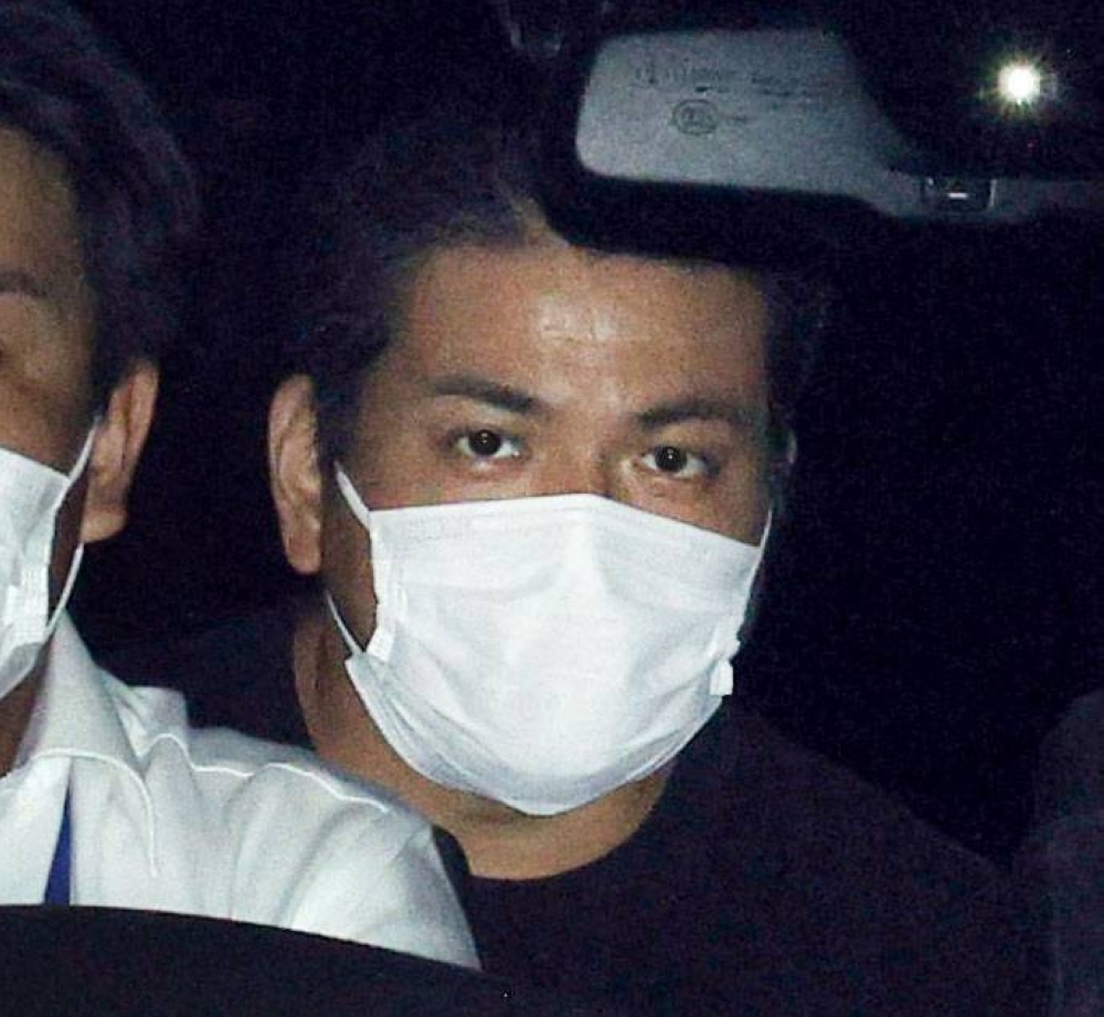 Yoshiaki Maeda is taken to a police station in Tokyo's Shinjuku Ward on Tuesday.