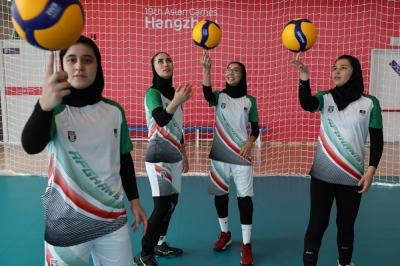 Members of the Afghan women's volleyball team spin balls for photos after practice in Hangzhou, China, on Wednesday.