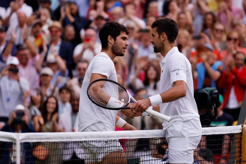 Novak Djokovic (right) and Carlos Alcaraz meet at the net following the 2023 Wimbledon final in London in July.