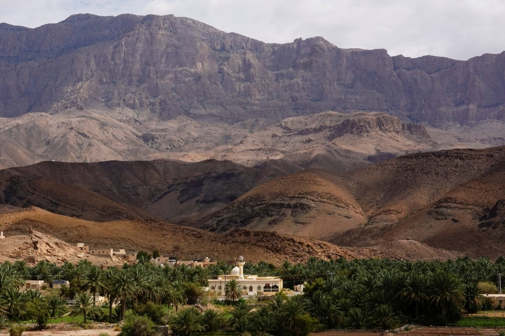 A mosque is seen against a backdrop of the Al Hajar Mountains near Al Ayn, Oman.
