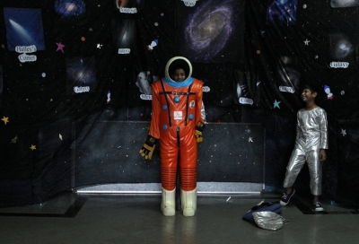 School children try on a space suit during an exhibition on space technology organized by the Indian Space Research Organisation and a college in Mumbai.