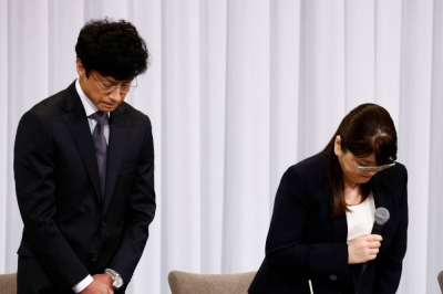 Johnny & Associates' outgoing head Julie Keiko Fujishima and its new chief, Noriyuki Higashiyama, bow to express their apology during a news conference in Tokyo last month. 