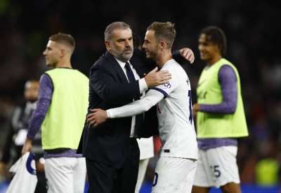 Tottenham manager Ange Postecoglou (left) and midfielder James Maddison celebrate after their Premier League win over Liverpool in London on Saturday.