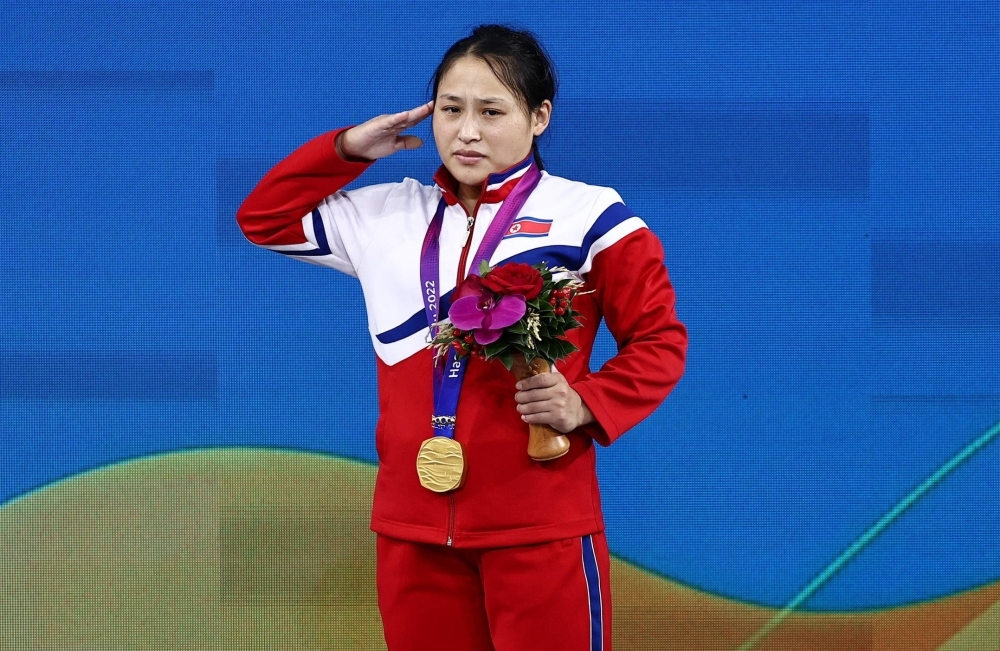 North Korea's Ri Song Gum salutes during the podium ceremony after winning the women's 49-kg final at the Asian Games in Hangzhou, China, on Saturday.