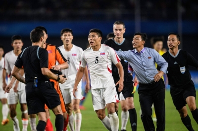 North Korea's Kim Kyong Sok (center) reacts after the men's quarterfinal football match between North Korea and Japan at the Asian Games in Hangzhou, China, on Sunday.
