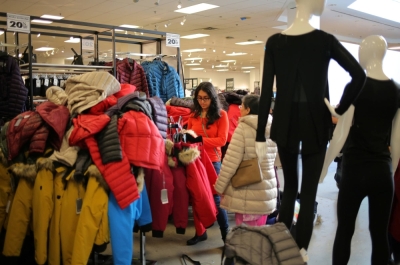 A shopper browses among winter coats at a department store in Mississauga, Ontario, Canada.
