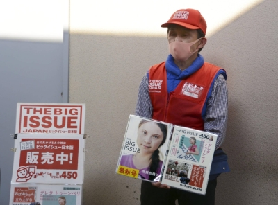 A man sells The Big Issue Japan magazine in Osaka in April 2020.